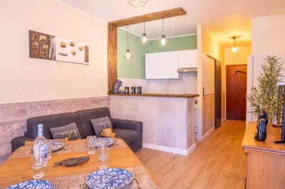 a dining room with a table and a kitchen at Casa Santa Lucia - Climatisé au bord de Mer in Santa-Lucia-di-Moriani