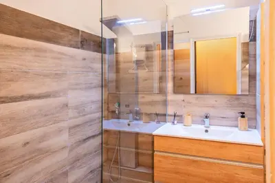 a bathroom with a sink and a mirror at Casa Santa Lucia - Climatisé au bord de Mer in Santa-Lucia-di-Moriani