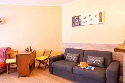 a living room with a couch and a table at Casa Santa Lucia - Climatisé au bord de Mer in Santa-Lucia-di-Moriani