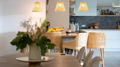 a kitchen with a table with a vase of flowers on it at A Casa Catalina - Charming villa in Afa