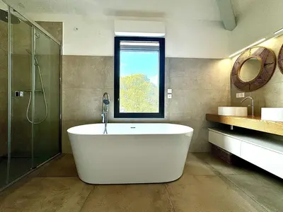 a bath tub in a bathroom with a window at A Casa Catalina - Charming villa in Afa