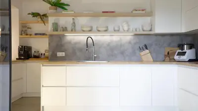 a kitchen with white cabinets and a sink at A Casa Catalina - Charming villa in Afa