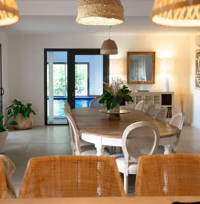 a dining room with a wooden table and chairs at A Casa Catalina - Charming villa in Afa