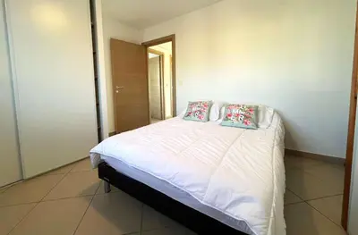 a bedroom with a bed with two pillows on it at MORIANI Centre Lumineux T3 à deux pas de la mer et commerces in Moriani Plage