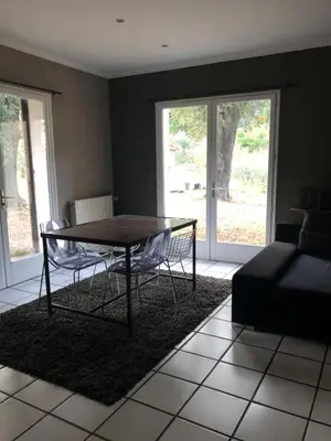 a living room with a table and a couch at Maison de caractère in Pietrapola