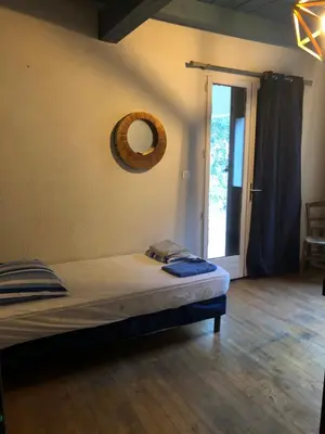 a bedroom with a bed and a mirror on the wall at Maison de caractère in Pietrapola