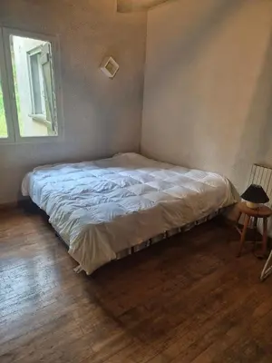 a bed sitting in a bedroom with a window at Maison de caractère in Pietrapola