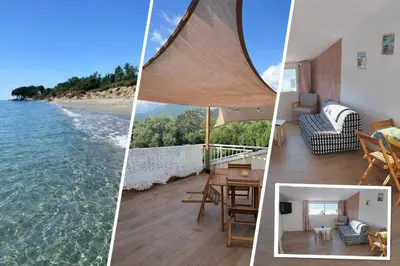 a patio with a wooden table and chairs on a roof at Appartement A madonna in Santa-Lucia-di-Moriani