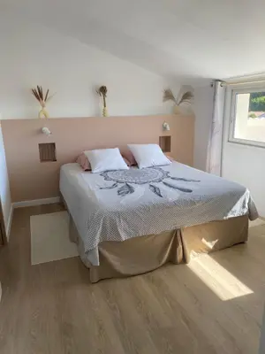a bedroom with a bed and a window at Appartement A madonna in Santa-Lucia-di-Moriani