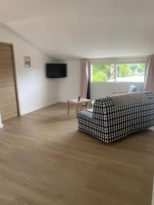 a living room with a couch and a table at Appartement A madonna in Santa-Lucia-di-Moriani