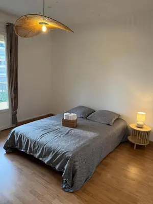 a bedroom with a bed with two towels on it at F3 parking gratuit Clim port 5min aéroport 10min in Ajaccio