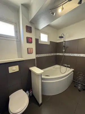 a bathroom with a tub and a toilet and a sink at F3 parking gratuit Clim port 5min aéroport 10min in Ajaccio