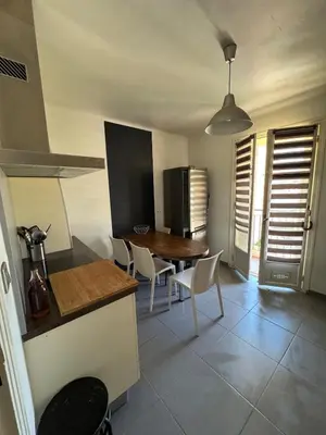 a kitchen and dining room with a table and chairs at F3 parking gratuit Clim port 5min aéroport 10min in Ajaccio