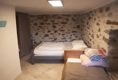 a bedroom with two beds in a room at Vue sur les montagnes Corses in Castellare-di-Mercurio