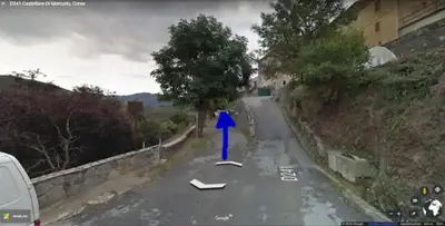 a road with a blue arrow on it at Vue sur les montagnes Corses in Castellare-di-Mercurio