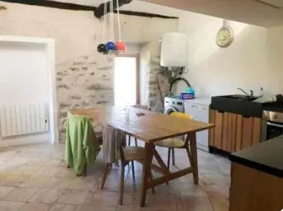 a kitchen with a table and chairs in a room at Vue sur les montagnes Corses in Castellare-di-Mercurio
