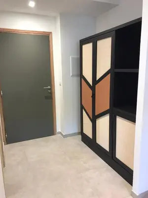 a room with a door and a room with a shelf at Hôtel du Golfe Pinarello in Pinarellu