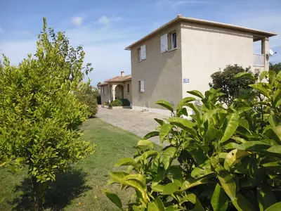 a house with a yard with trees in front of it at Bed and Breakfast in LʼArena