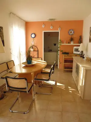a kitchen with a table and chairs in a room at Bed and Breakfast in LʼArena