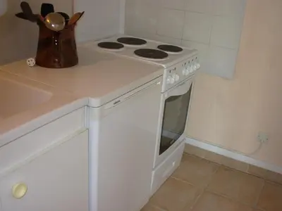 a kitchen with a white stove and a sink at Bed and Breakfast in LʼArena