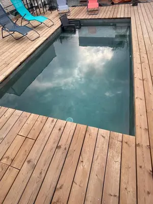 a pool with a wooden deck and a swimming pool at Villa de luxe Piscine 5 chambre in Vescovato