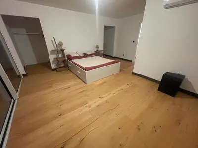 a bedroom with a bed and a wooden floor at Villa de luxe Piscine 5 chambre in Vescovato