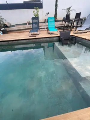 a swimming pool with chairs in the water at Villa de luxe Piscine 5 chambre in Vescovato