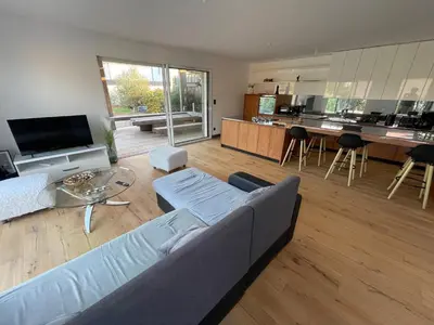 a living room with a couch and a kitchen at Villa de luxe Piscine 5 chambre in Vescovato