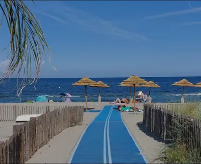 a blue path on a beach with umbrellas at Villa de luxe Piscine 5 chambre in Vescovato