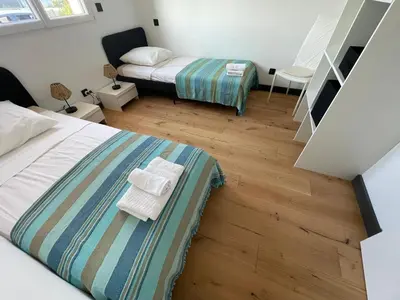 a bedroom with two beds with towels on the floor at Villa de luxe Piscine 5 chambre in Vescovato