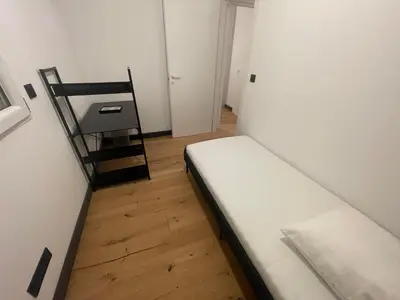 a small room with a bed and a chair at Villa de luxe Piscine 5 chambre in Vescovato