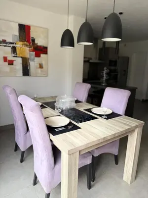 a dining room table with purple chairs and a dining room at Villa Maria in Borgo