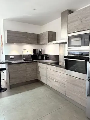 a kitchen with wooden cabinets and stainless steel appliances at Villa Maria in Borgo