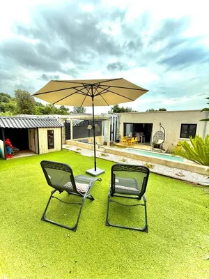 two chairs and an umbrella in a yard at Villa Maria in Borgo