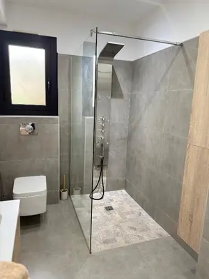 a bathroom with a shower and a toilet at Villa Maria in Borgo