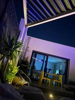 a patio with a table and chairs at night at Villa Maria in Borgo