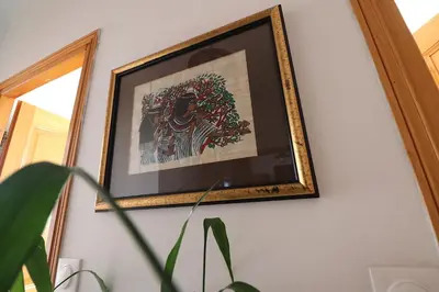 a picture hanging on a wall with a plant at Spacieux Appartement Vue Mer et Montagne en dernier étage avec Terrasse - Parking et Wifi in Ajaccio