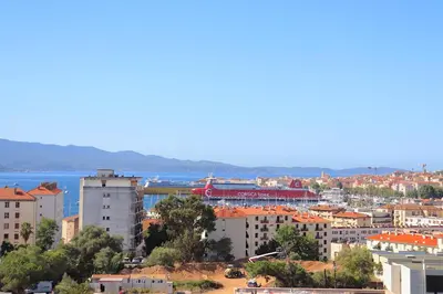 a view of a city with buildings and the water at Spacieux Appartement Vue Mer et Montagne en dernier étage avec Terrasse - Parking et Wifi in Ajaccio