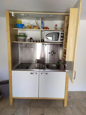 a small kitchen with a sink and a microwave at Studio a petit prix in Castellare-di-Mercurio