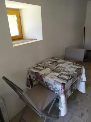 a table and a chair with a box on it at Studio a petit prix in Castellare-di-Mercurio