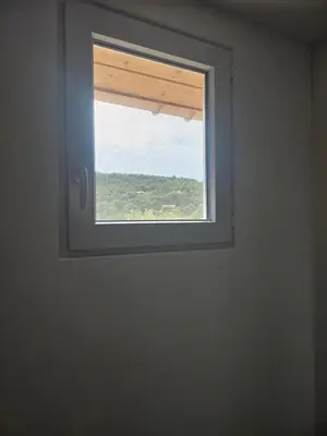 a window in a white room with a view at Maison Bois in Grosseto-Prugna