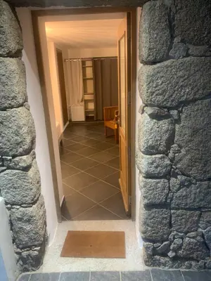 a view of a hallway through a stone wall at A Teghja in Figari