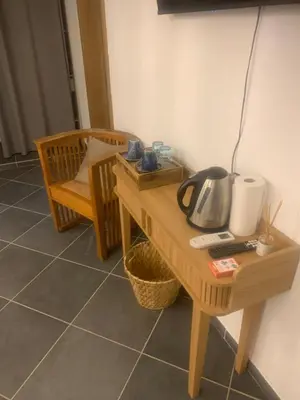 a room with a table with a microwave and a chair at A Teghja in Figari