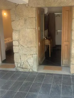 a room with a stone wall and a doorway at A Teghja in Figari