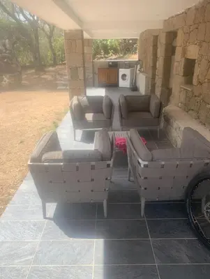 a living room with couches and a table at A Teghja in Figari