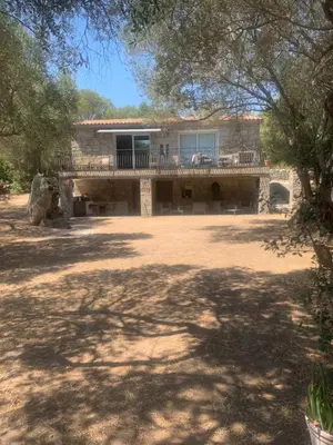 a house with a large yard with a patio at A Teghja in Figari