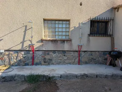a building with a window and a grill in front of it at Andemu Pianottoli Caldarello in Pianottoli-Caldarello