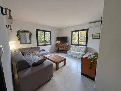 a living room with a couch and a table at Andemu Pianottoli Caldarello in Pianottoli-Caldarello