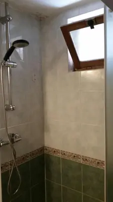a bathroom with a shower with a window at Bergerie Restaurée in Corte