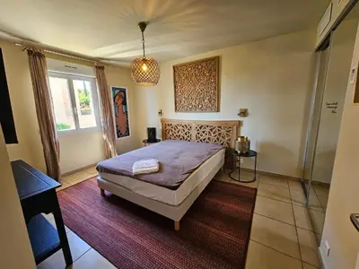 a bedroom with a large bed and a window at Appartement Paolina Vue Mer Sari-Solenzara Corse in Sari Solenzara